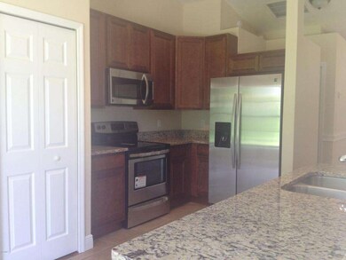 Grainte & Stainless Tiled Kitchen