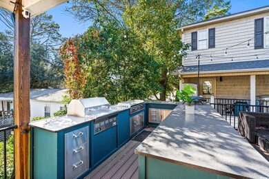 Wooden terrace featuring exterior kitchen and a sink