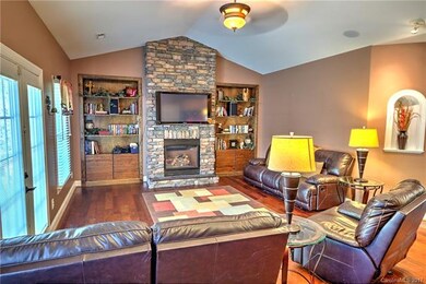 Great room with cathedral ceilings and tons of built ins. 50 inch plasma TV and surround sound included.