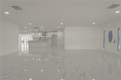 Unfurnished living room with light marble finish f