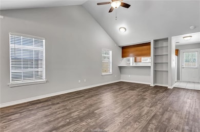 Unfurnished living room featuring a ceiling fan, h