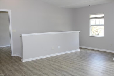 Empty room featuring baseboards and wood finished 