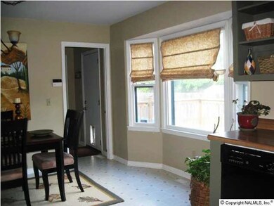 Another angle of the dining area leading to laundry room and garage