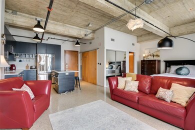Living room with dark aggregate flooring and a hi