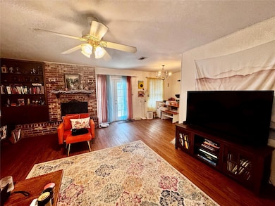 Living area with wood finished floors, a textured