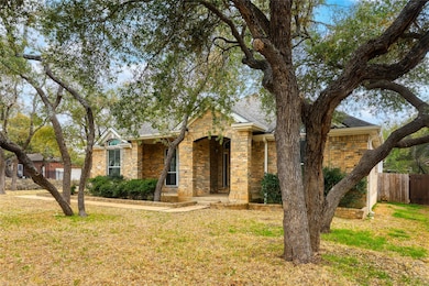 View of front facade with brick siding, a porch, 