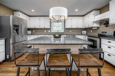Custom cabinets, granite counter tops, and huge island for entertaining and homework!
