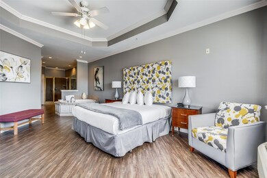 Bedroom with ceiling fan, hardwood / wood-style fl