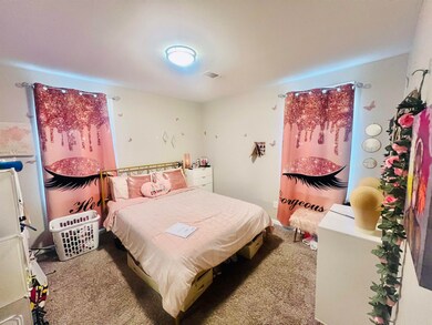 Bedroom featuring light colored carpet