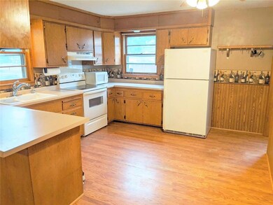 Open kitchen with breakfast counter and dining are