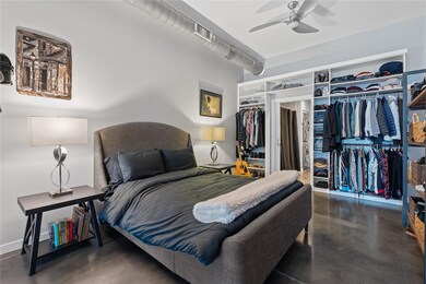 Bedroom featuring finished concrete flooring and 