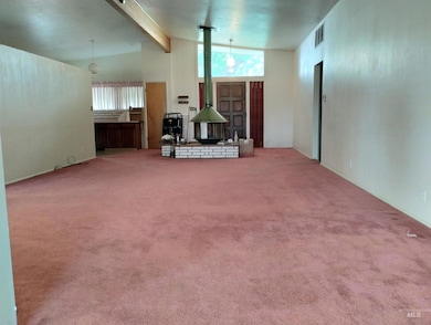 Living room with beam ceiling, carpet floors, and high vaulted ceiling