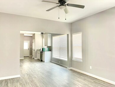 Unfurnished living room featuring light wood-type flooring and ceiling fan