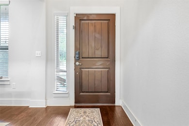 Entryway featuring wood finished floors and baseb