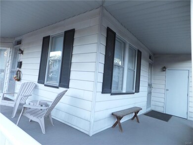 Wrap around porch with storage shed for #15