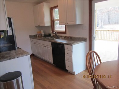 Eat-in kitchen with wood floor, stove, dishwasher
