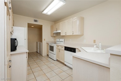 Kitchen with washer and clothes dryer, white appli
