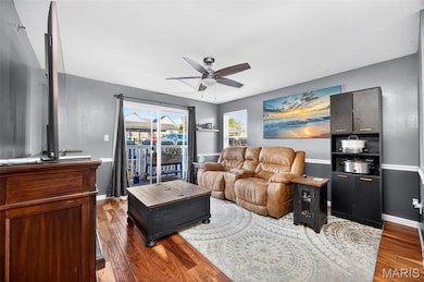 Living room featuring wood finished floors and a ceiling fan