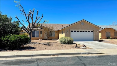 Ranch-style house with a garage, driveway, and stu