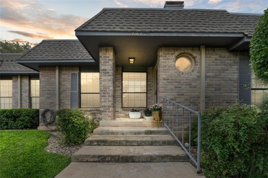 Property entrance featuring a shingled roof and b