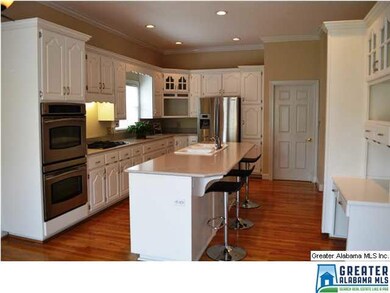 Updated eat-in kitchen with white cabinetry, quart