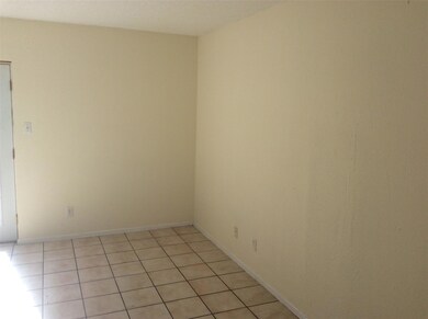 Empty room featuring light tile patterned floorin