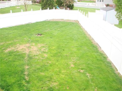 The large, flat, fenced backyard also features an 