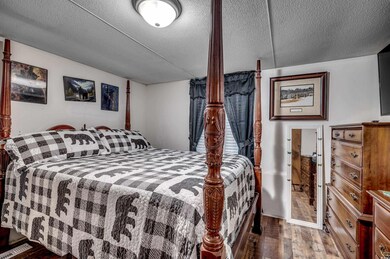 Bedroom with wood-type flooring and a textured cei