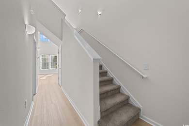 Staircase featuring wood-type flooring