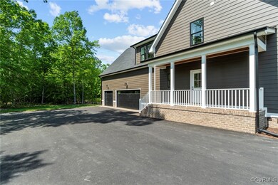 View of side of home with covered porch and a gara