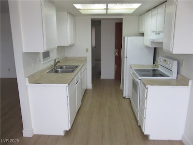 Kitchen featuring a sink, white electric range, un