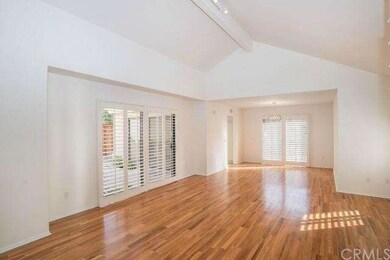 The expansive living room features refinished hard
