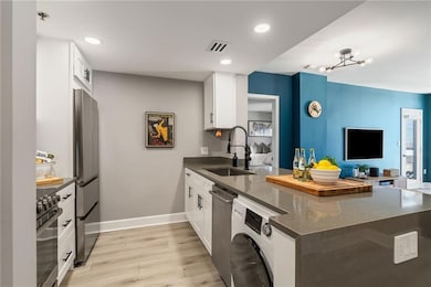 Bright, updated kitchen with stainless steel appliances, stone countertops, and plenty of cabinet space. Perfect for cooking or entertaining.