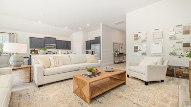 Living room with light hardwood / wood-style floors and lofted ceiling
