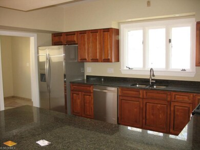 Kitchen view from breakfast bar. Door leads to lau