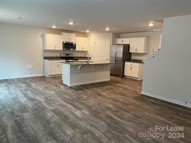 family room open concept to kitchen with dining area