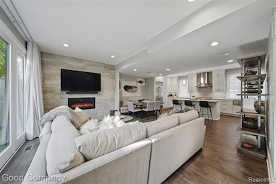 Living area featuring recessed lighting, dark wood-style floors, and a tiled fireplace