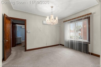 Spare room with light carpet and a chandelier