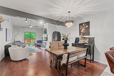 Dining room featuring track lighting, a chandelie
