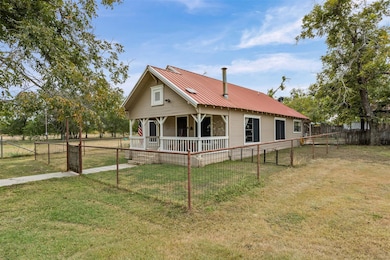 Rear view of house featuring covered porch and a 