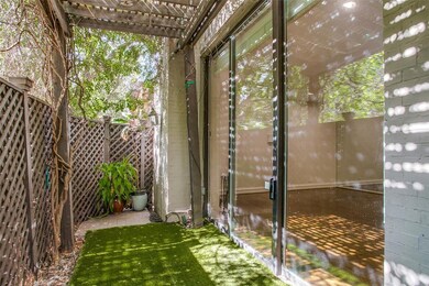 Pergola covered private patio with turf.