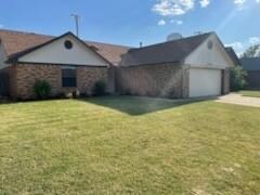 Single story home with a front lawn and a garage