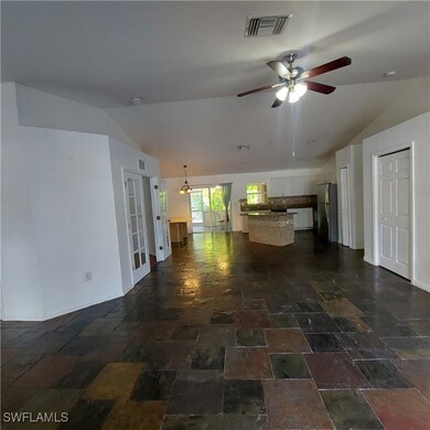Unfurnished living room featuring lofted ceiling,
