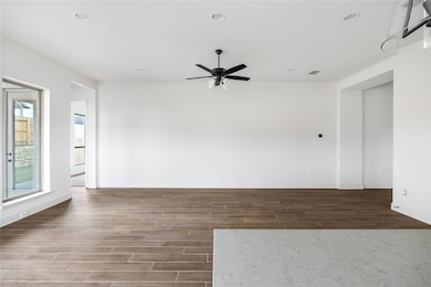 Spare room with wood finished floors, recessed li