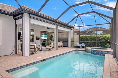 Pool and Spa with outdoor living space and remote storm shades for added comfort and security.