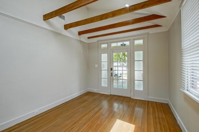 Wonderful living room with high ceilings & exposed beams.