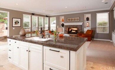 The large kitchen opens into the Family Room. Sens