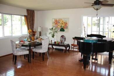 Combination living and dining room has hardwood fl