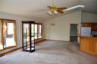Looking from the Living Room towards the Dining Room. Kitchen is to the right. The display case down not convey. There is a skylight for natural lighting.