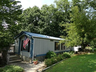 Exterior Front. Sitting on 1.68 acres with mature trees & flower beds - on a permanent block foundation w/workshop